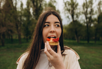 girl in the park eats faggots and smiles