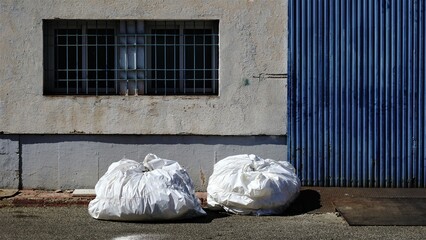 garbage bags on industrial area sidewalk