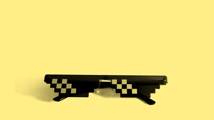Pixel 8bit style. Funny swag pixilated thug life sunglasses on yellow background. Gangster meme...