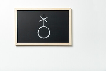 Non-binary or genderqueer community symbol painted with chalk on a blackboard.