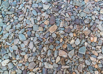 Nature pebbles background. Blue pebbles texture. Stone background