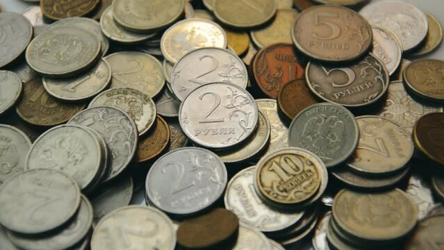 Coins Russian rubles background on the table. Translate: ruble, kopeck