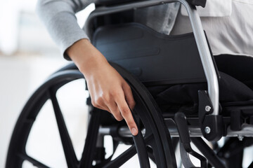 Shes ready to get moving. Cropped shot of an unrecognizable businesswoman sitting in a wheelchair in the office.