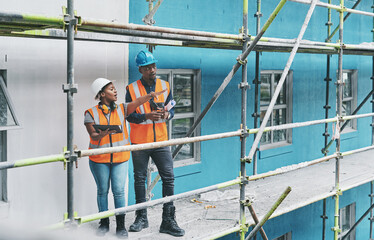Shaping the future of construction with the help of smart apps. Shot of a young man and woman using a digital tablet while working at a construction site.