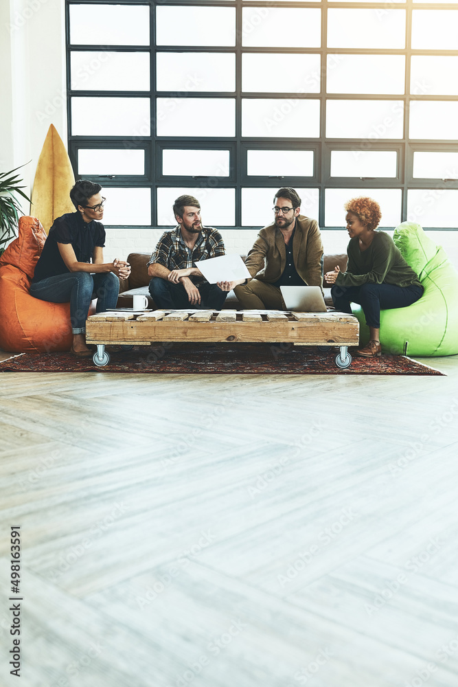 Poster Keep an open mind when exploring new possibilities. Shot of a group of young designers discussing paperwork.