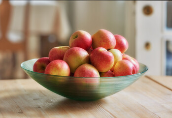 An apple per day keeps the doctor away. Glass bowl with lots of healthy apples - a really healthy and tempting treat..