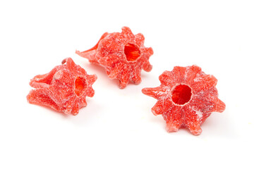 Candied hibiscus flowers isolated on white background.