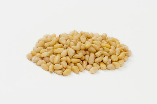 Pine Nuts Isolated on a White Background. Hulled cedar seeds