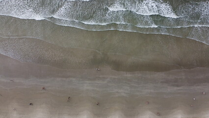 Aerial photo with drone on the beach showing the waves of the sea.