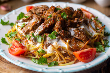 Turkish food; Cokertme Kebab - Beef meat kebab with yoghurt and french fries