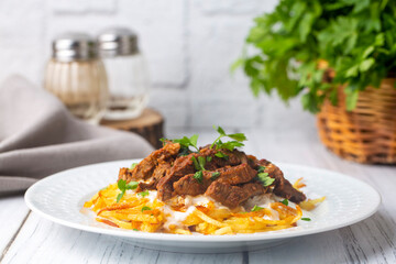 Turkish food; Cokertme Kebab - Beef meat kebab with yoghurt and french fries