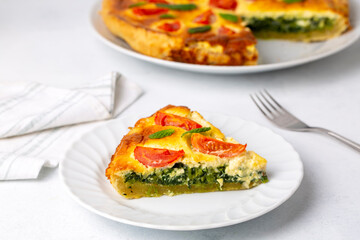 Vegetarian homemade pie, Quiche with tomatoes, spinach and feta cheese, spinach quiche (Turkish name; ispanakli kis)