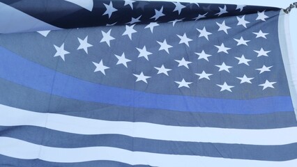 Black white american monochrome flag with blue stripe or line, police support. Solid star-spangled banner waving in wind breeze.
