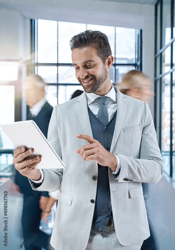 Poster Making decisions at a click of a button. Shot of an attractive, smiling businessman searching on his tablet.