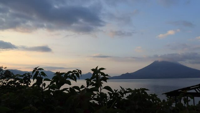 sunrise at lake atitlan from the shores of santa cruz la laguna , guatemala