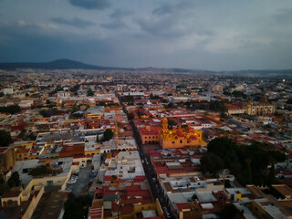 Fototapeta na wymiar hermosa vista aerea de dron de el centro de queretaro mexico, drone clouds, city, colonial city, green grass, football filed