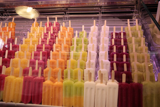 Row of homemade fruit smoothie sundaes on display shelves