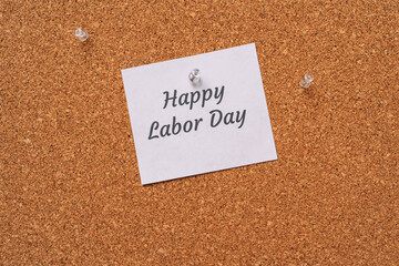 Happy labor day sticker nailed to chalkboard.