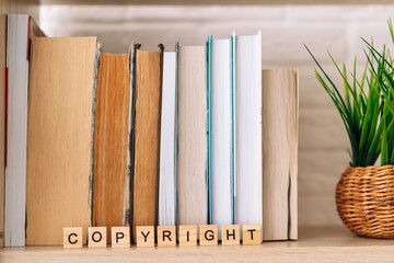 Word copyright made of letters in front of books.