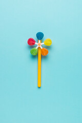 Colorful candy on a stick on a blue background. Flat lay.