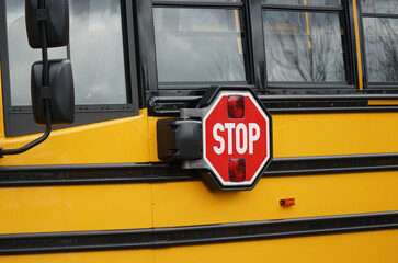 Close up on school bus with stop sign