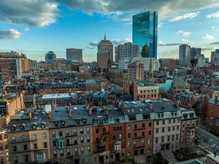 Aerial view of modern apartments and office buildings in downtown Boston with dramatic coludy sky