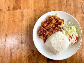 Homemade Tonkatsu rice (Thai style) with shredded cabbage salad. (Fried pork cutlet rice)