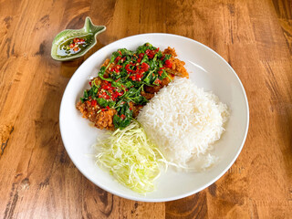 Homemade food, Fried pork cutlet top on stir fried basil serve with fish sauce (Thai style)