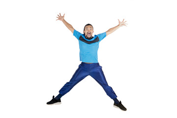 Fototapeta na wymiar Happy man jump on studio while wears sportswear