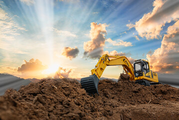 Excavator with Bucket lift up are digging  soil in the construction site on sky and sunbeam ...
