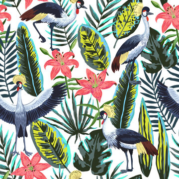 Vector seamless pattern with tropical jungle leaves and flowers and crowned crane birds. 