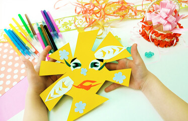 DIY crafts. Child preparing  for Mothers Day, making greeting card. Girl making paper sun as gift for Mothers day, Birthday or Valentines day . Arts  crafts concept.