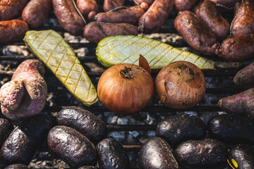 Delicious grilled onions and eggplant. Grilled vegetables with sausages and blood sausages.