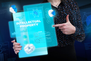 Business, Technology, Internet and network concept. Young businessman working on a virtual screen of the future and sees the inscription: Intellectual property