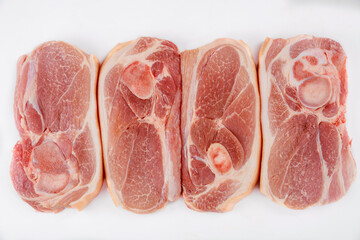 Close up of sliced raw pork shoulder with skin.