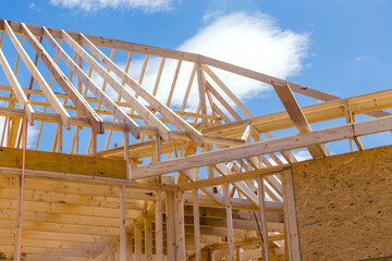 Obraz premium Panoramic view of wooden frame house under construction, roof beams