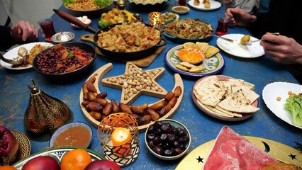 Ramadan iftar Eid. Muslim family has dinner at home. Table with traditional food. Eid al-Fitr...