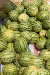 Fototapeta na wymiar Watermelon being sold in roadside market in sun