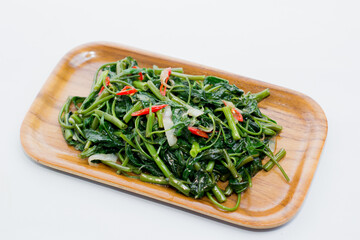 Processed kale. Served on a wooden plate. Cah Kangkung.