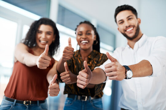 Thumbs up to opportunities. Cropped portrait of a diverse group of business colleagues standing together in the office and showing a thumbs up. - Powered by Adobe