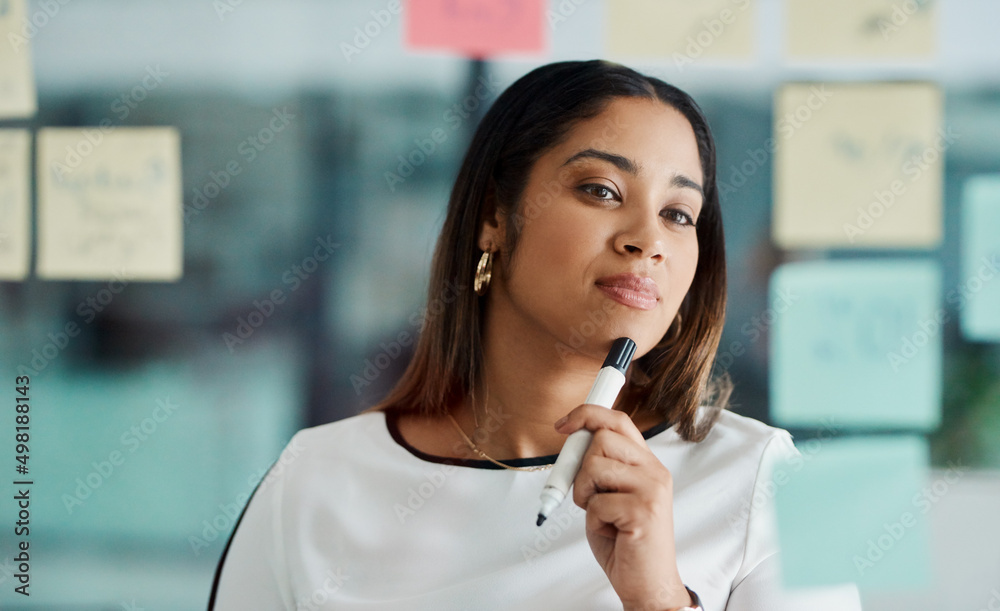Poster Brainstorming improves your critical thinking and problem-solving skills. Shot of a young businesswoman brainstorming with notes on a glass wall in an office.