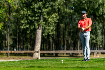 Young golfer getting ready to play from a tee box