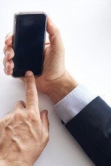 Logging in to success. Closeup shot of a businessman using a cellphone against a white background.