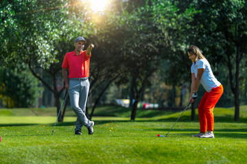 Golf vacation for couples, playing golf in a beautiful sunny weather