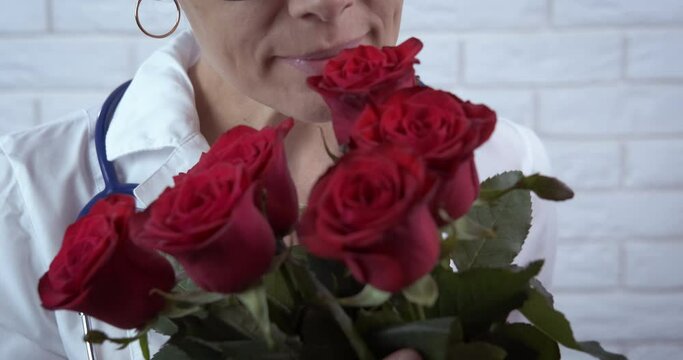 Doctor celebrate with flowers. A doctor with red roses celebrate doctor's day in the hospital.