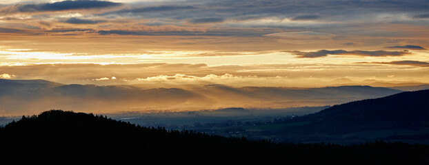 Sunset with dramatic cloudy sky over mountains shape, beautiful nature landscape