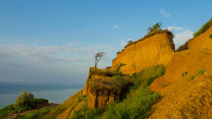 Seashore with sheer cliff. View on The Black Sea coast near the village of Sanzhiyka in Odessa region, Ukraine. Seascape withclay steep coast and sea on the background. 