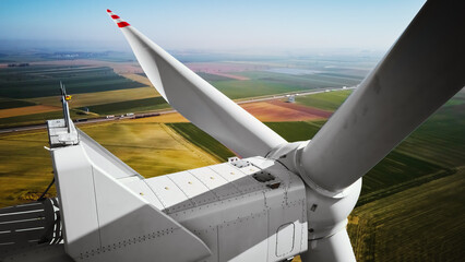Aerial view of close up windmill turbine in countryside area, Wind power and renewable sustainable...
