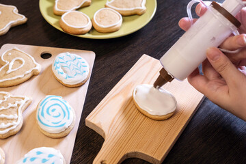 women's hands close-up cover gingerbread with sugar glaze. concept of preparation for Easter