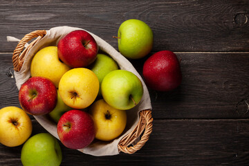 Naklejka na ściany i meble Colorful ripe apple fruits in basket